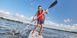 Happy,Boy,Paddling,On,Stand,Up,Paddleboard.,Cheerful,Child,Having