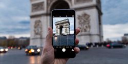 Student taking picture of the Arc de Triomphe