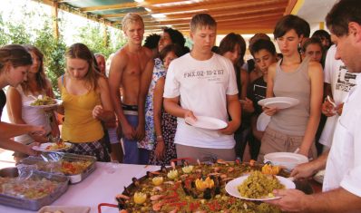 Students getting Paella