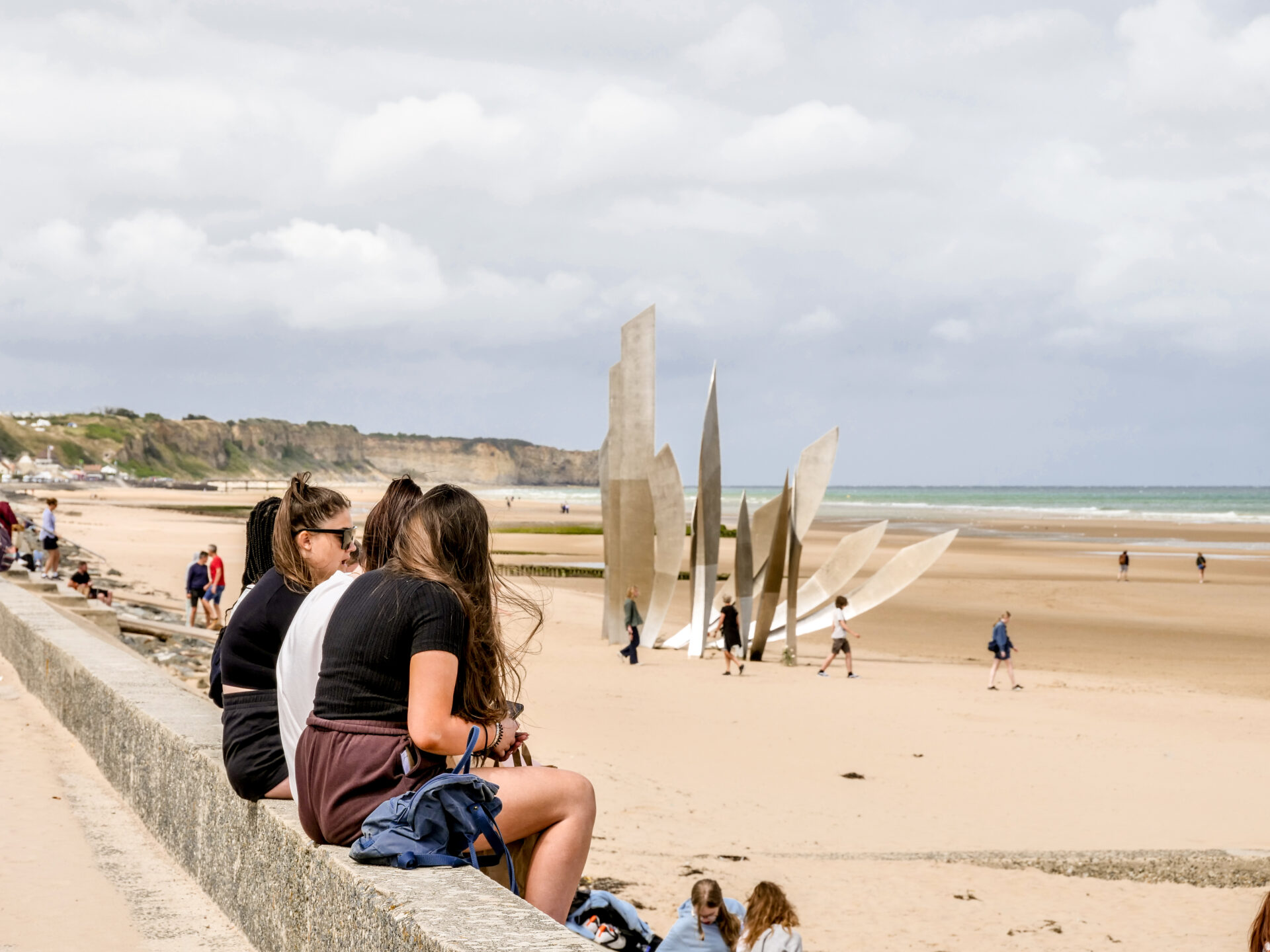 Students sitting on Omaha Beach in Normandy