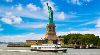 Statue,Of,Liberty,And,Tourist,Ship,Ferry,In,New,York