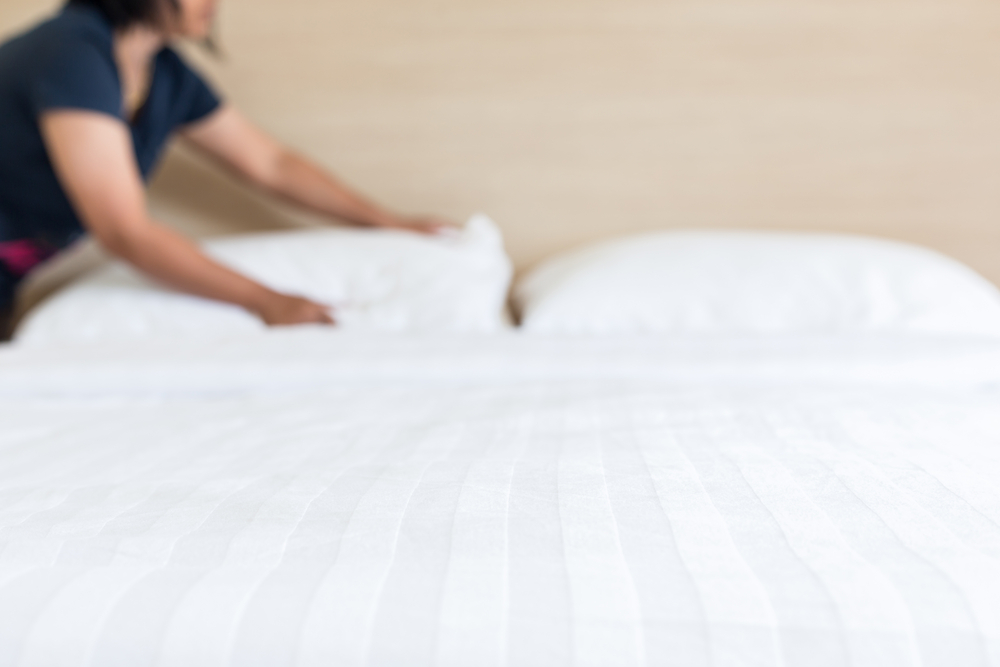 Hotel staff making a bed