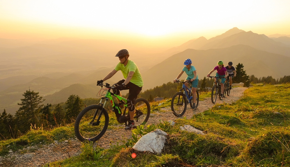 Group mountain-biking at sunrise