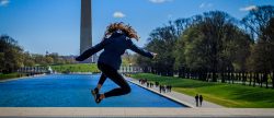 Student leaping by the Washington Monument