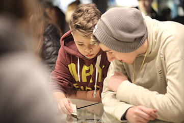 Students discussing exhibit in the museum