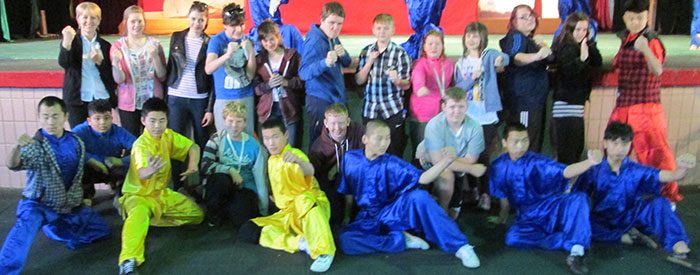 School students taking on a kung fu experience