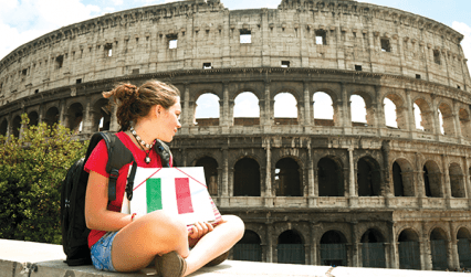 Student holding Italian flag outside the Colosseum, Rome