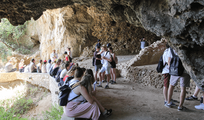 Students exploring rock formations in the Bay of Naples