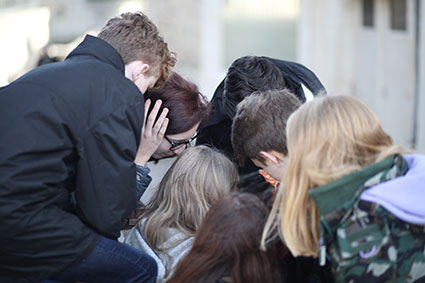 Students huddling for a team challenge