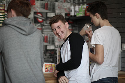 Student standing by the tuck shop smiling