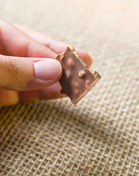 A,Man,Holding,Delicious,Chocolate,Bar,With,Hazelnuts