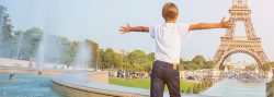 Boy running towards Eiffel Tower
