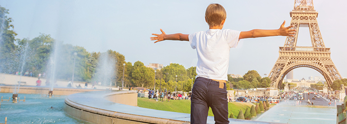 Boy running towards Eiffel Tower