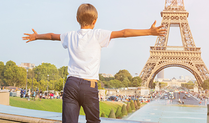 Boy running towards Eiffel Tower