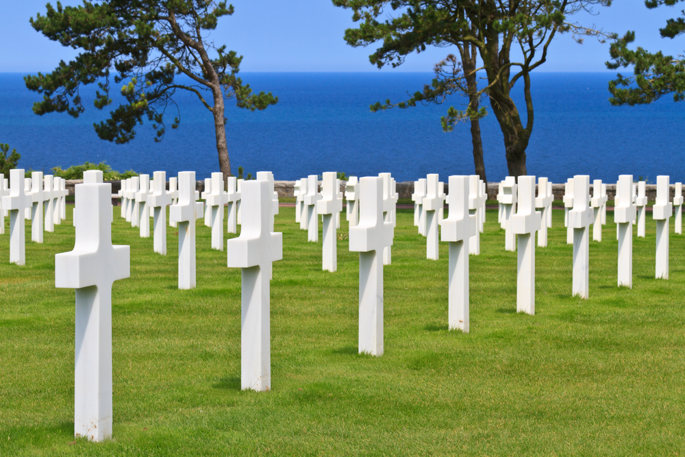 The peaceful American war cemetery near Omaha Beach with a blue sea and sky background