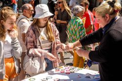 Students buying bracelets at the Caen market
