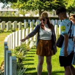 Students reflecting at a war cemetery