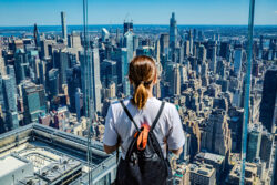 Student looking at the views over New York from a skyscrapper