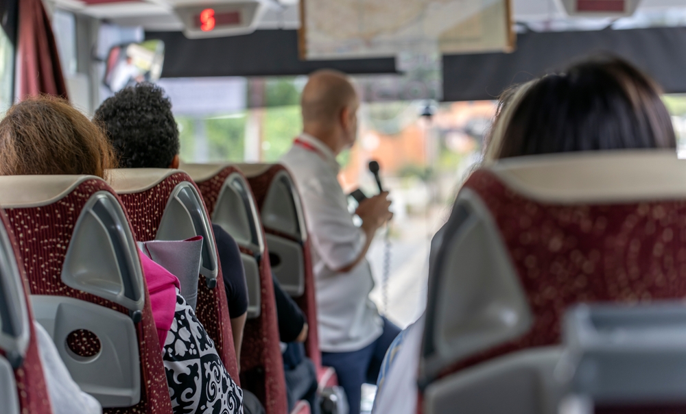 Tour guide giving a speech on a coach tour
