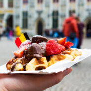 Belgium,Waffle,With,Chocolate,Sauce,And,Strawberries,,Bruges,City,Background,