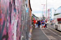 Group standing in front of the iconic Berlin Wall