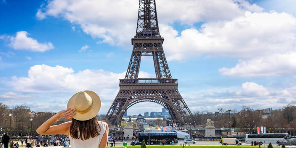 Girl looking at the Eiffel Tower in Paris on a sunny day
