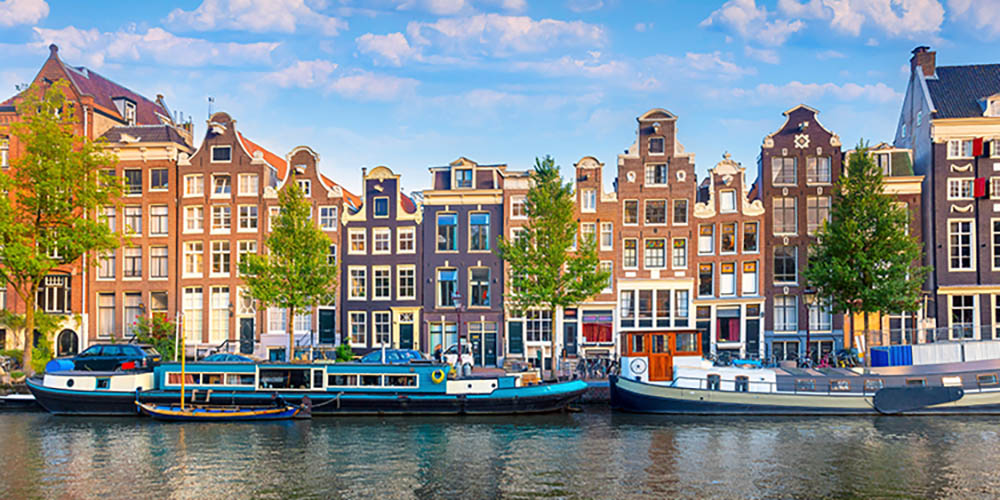 Traditional houses set amongst river boats in Amsterdam