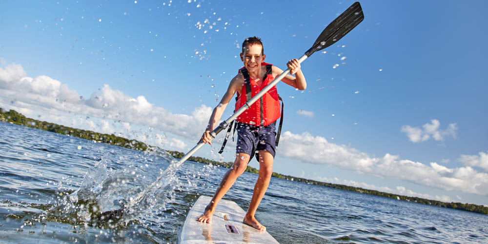 Young boy on a stand-up paddle board