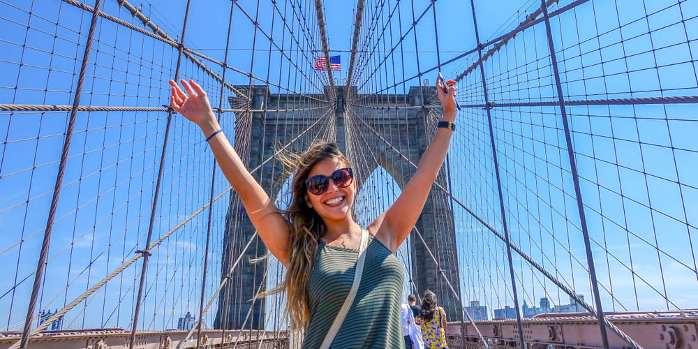 Happy student on the Brooklyn Bridge, New York