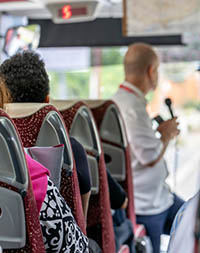 Tour guide giving a speech on a coach tour