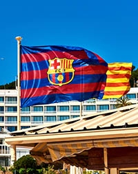 Waving flag of FCB (Futbol Club Barcelona). Tossa de Mar town. Catalonia, Spain