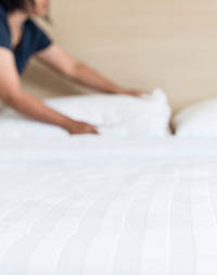 Hotel staff making a bed
