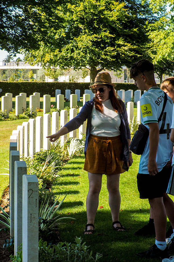 Students reflecting at a war cemetery
