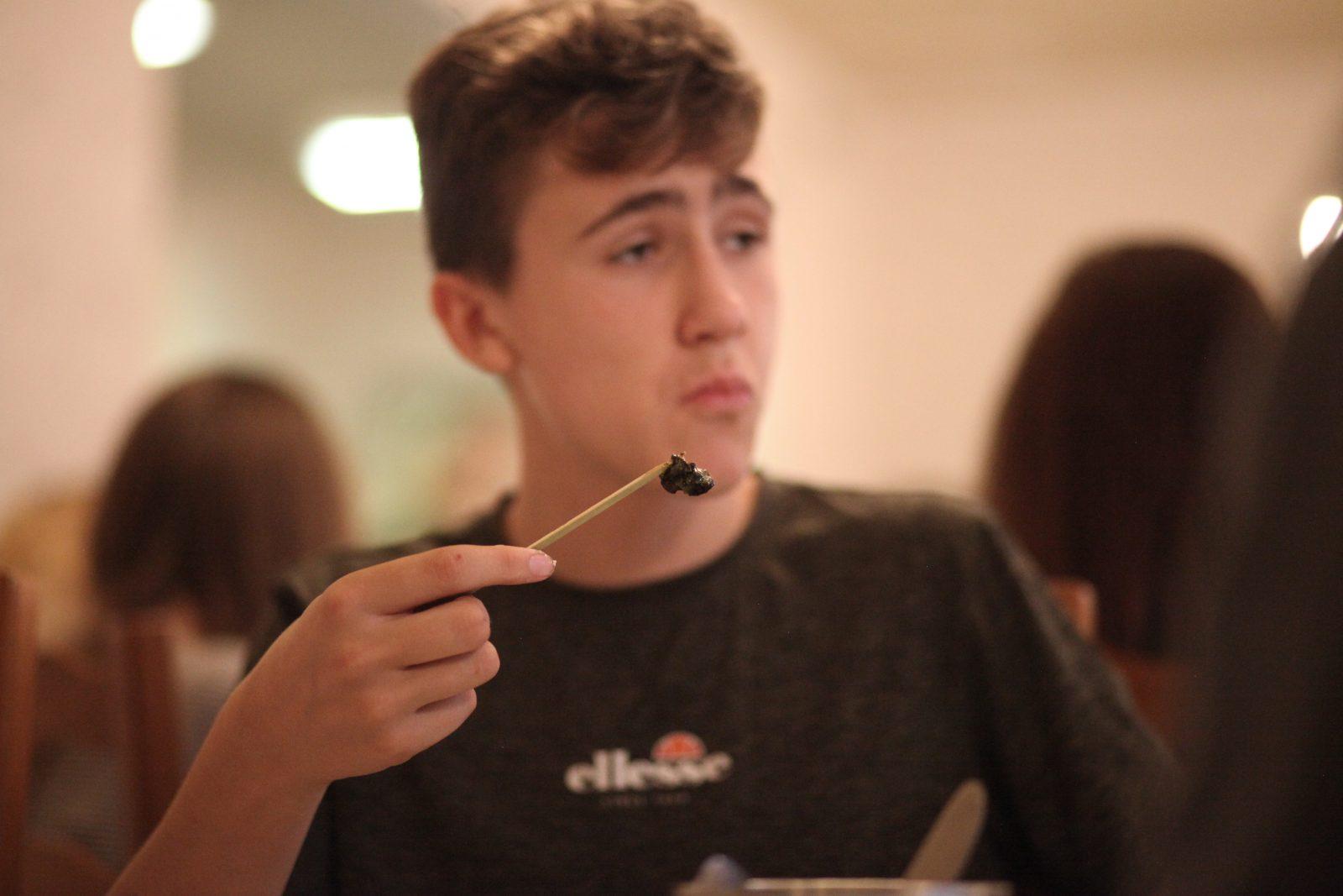 Boy eating a snail