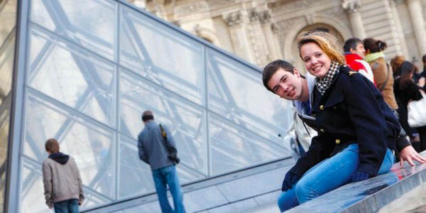 Students sitting outside the Louvre Museum in Paris