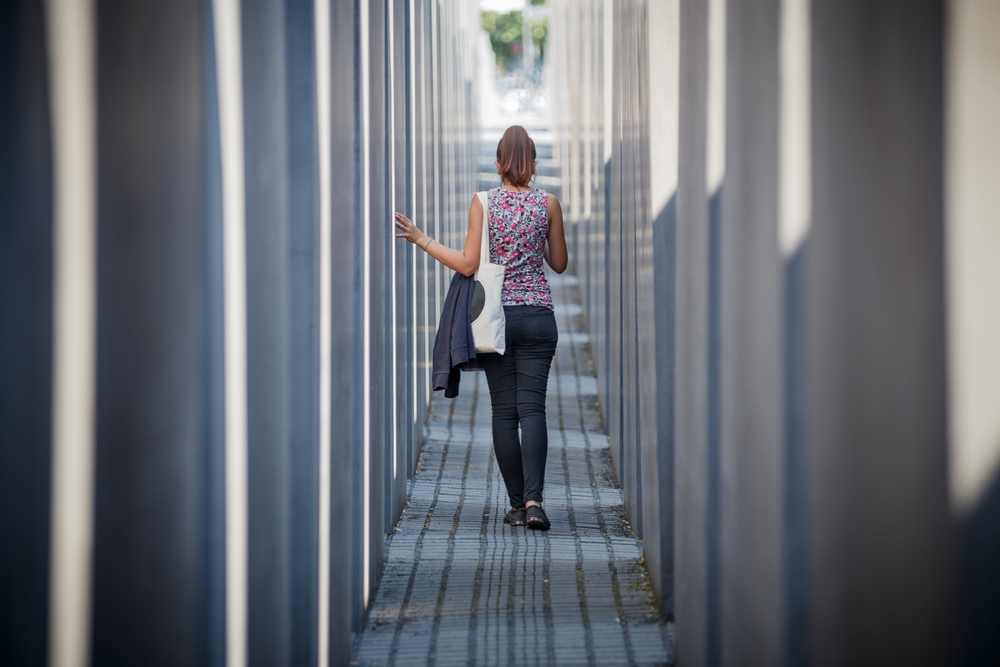 A lady walking through a memorial in Berlin