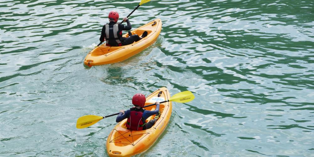 Students kayaking in the calm waters