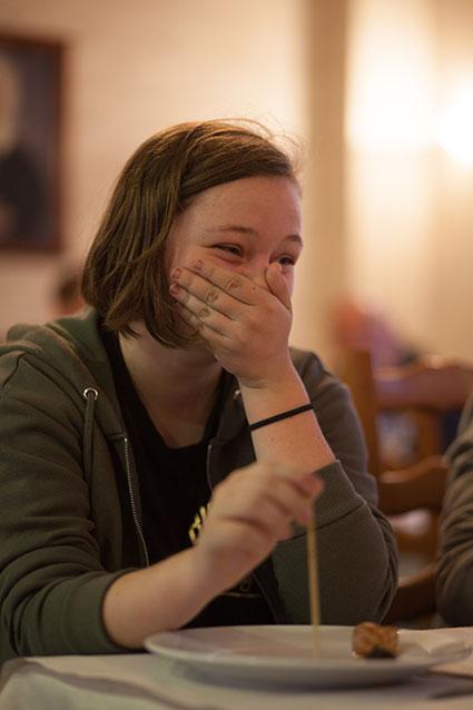 Student laughing during snail tasting evening Student laughing during snail tasting evening