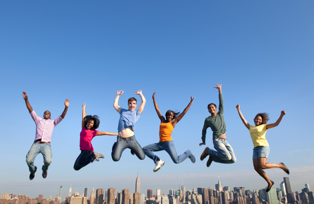 Group Of Multiethnic People Jumping At New York City Skyline