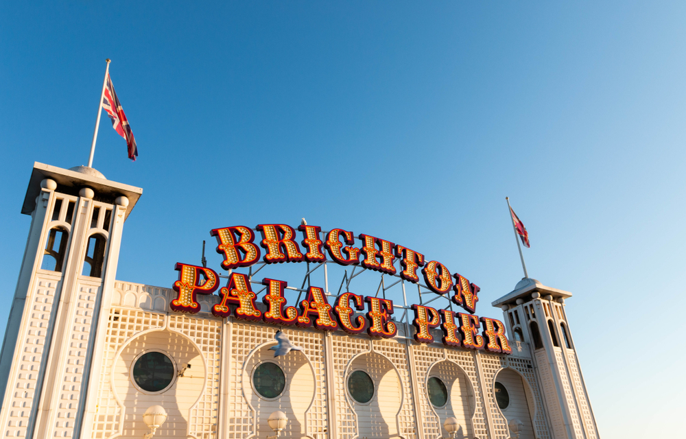 The Brighton Palace Pier entrance against a blue sky backdrop