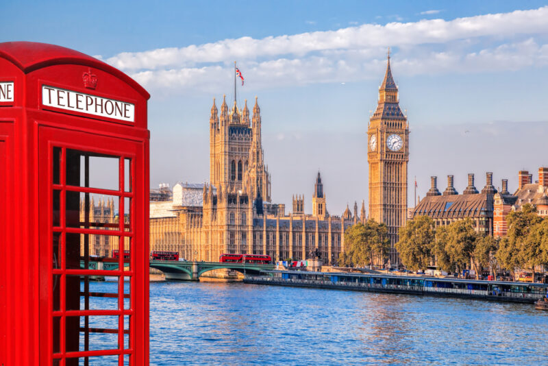 Iconic red phone box and Big Ben in the distance in London, UK