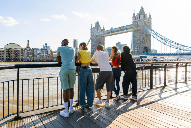 Group of students by the River Thames and Tower Bridge in London