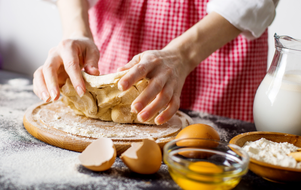 Lady making bread from scratch at a bakery