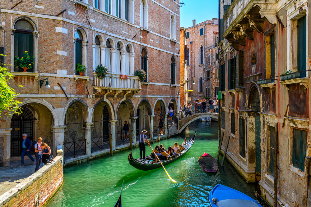 Gondola on the blue waters of the Venice canals