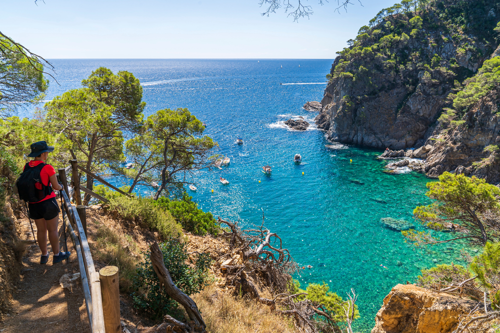 Woman trekking in Pedrosa Cove, Costa Brava