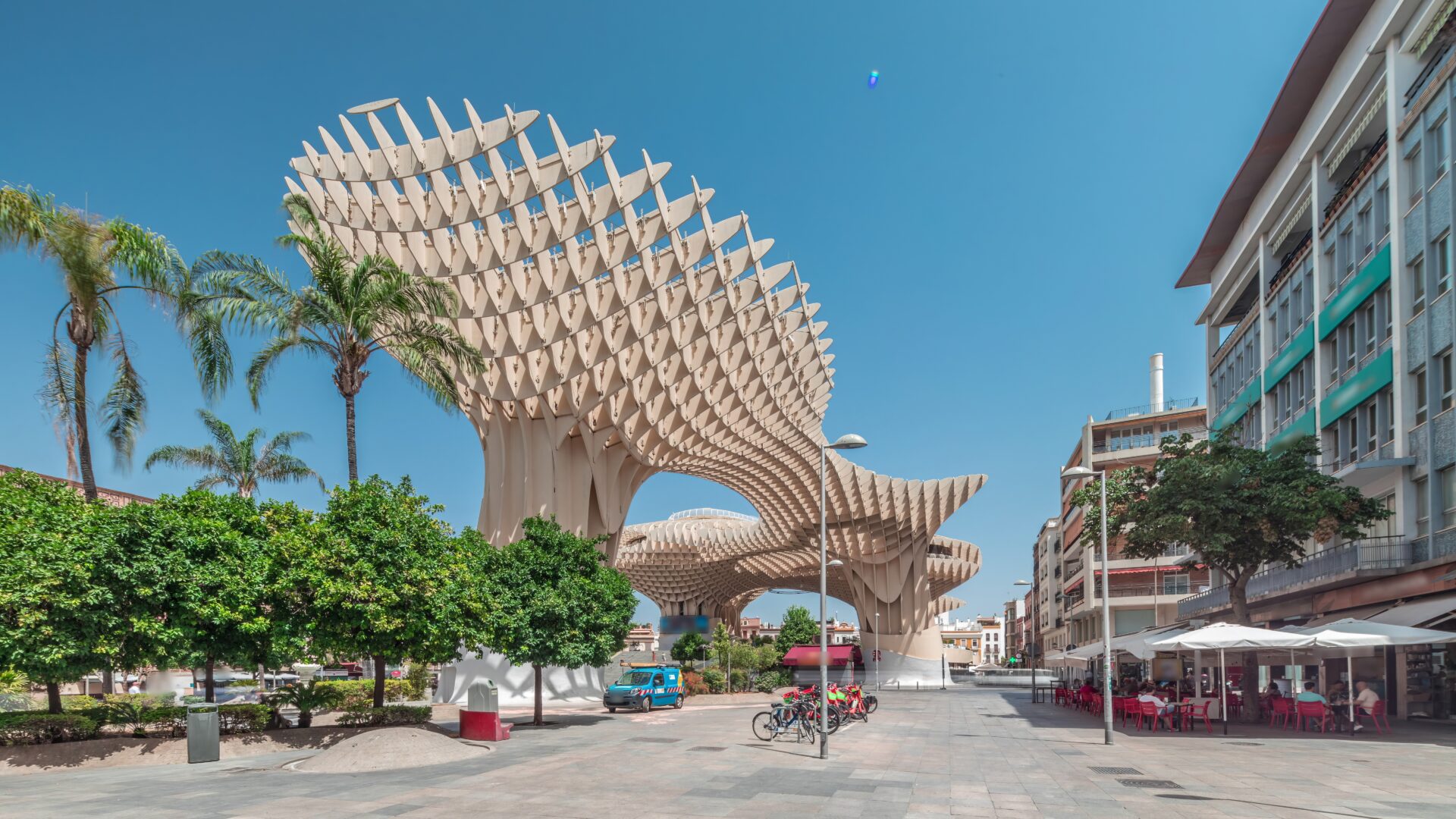 Metropol Parasol in Encarnacion Square timelapse hyperlapse, a futuristic wooden structure with a panoramic walkway and an archaeological museum. Blue sky, trees and cityscape in Seville, Spain.
