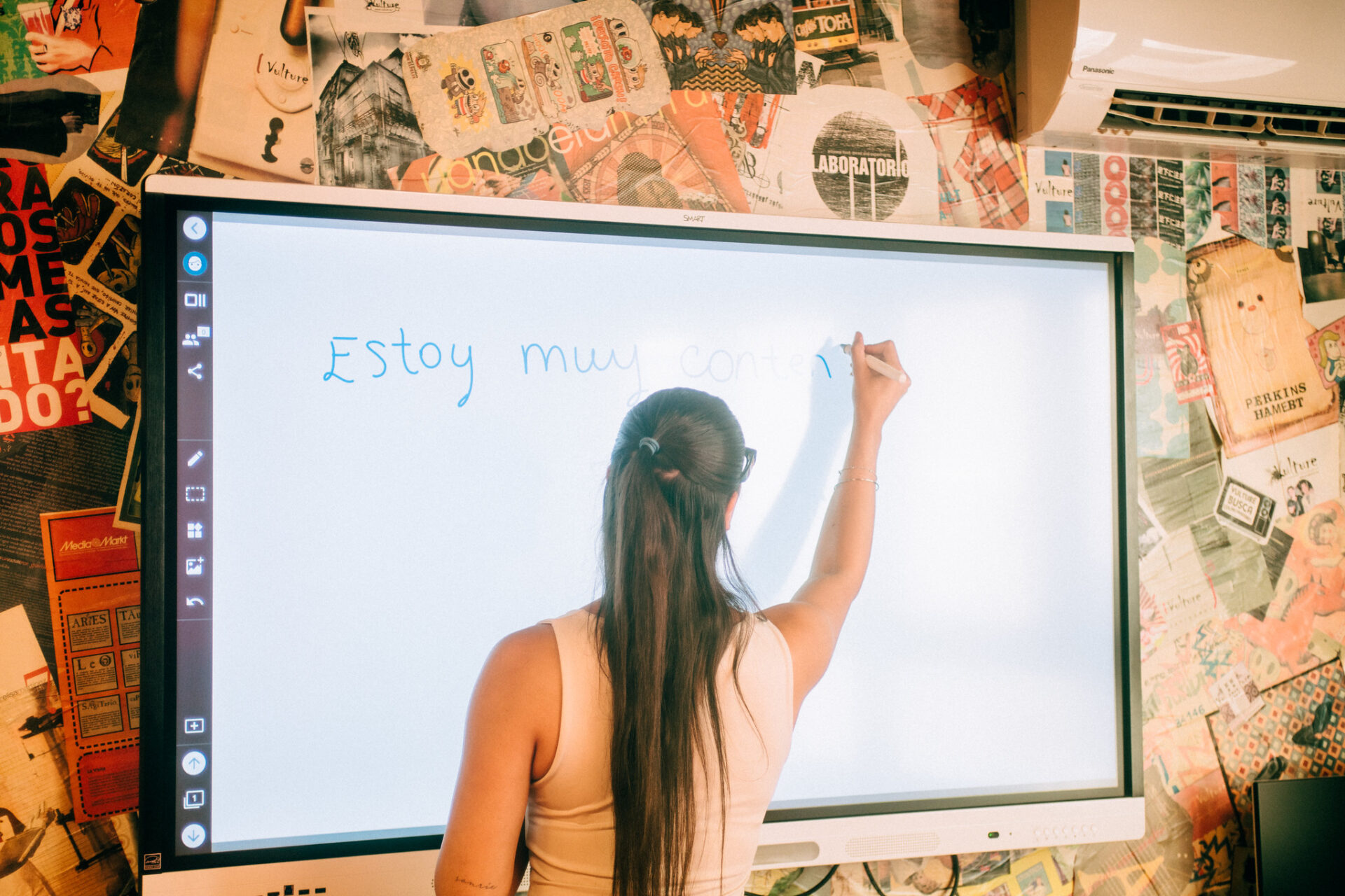 Student writing on a board at a Spanish language in Taronja School, Valencia