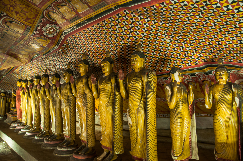 A collection of golden Buddha statues in Dambulla Cave Temple, Sri Lanka