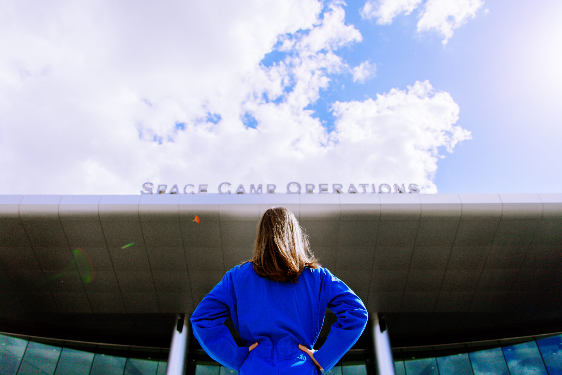 Female student standing in front of Alabama Space Camp