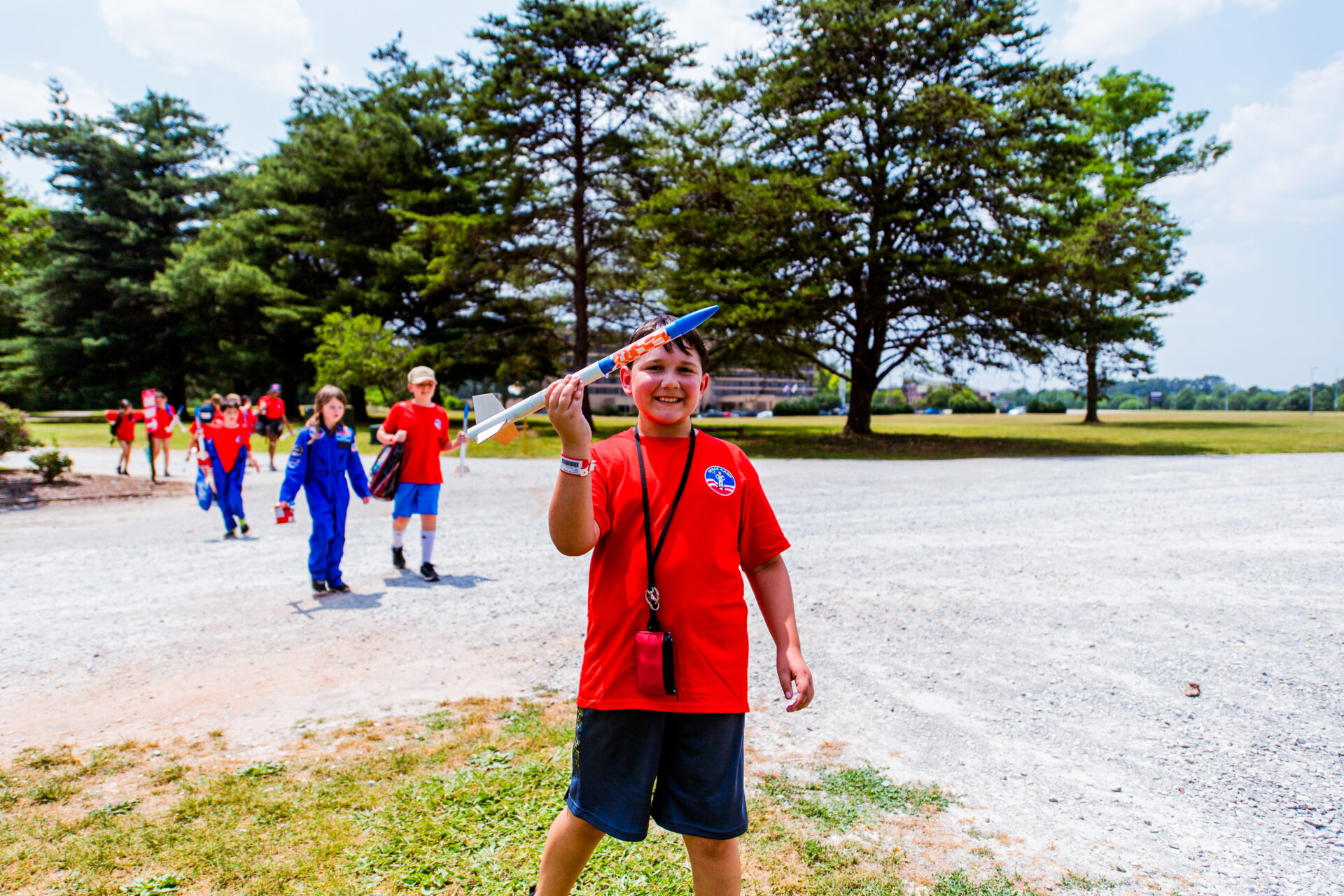 Student boy playing with a rocket he built at Alabama Space Camp